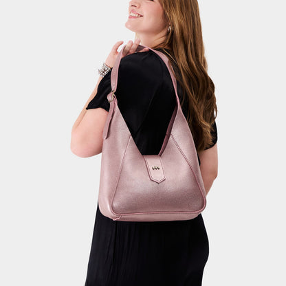 Supernova | Model wearing structured hobo shoulder bag with adjustable strap and magnetic closure
