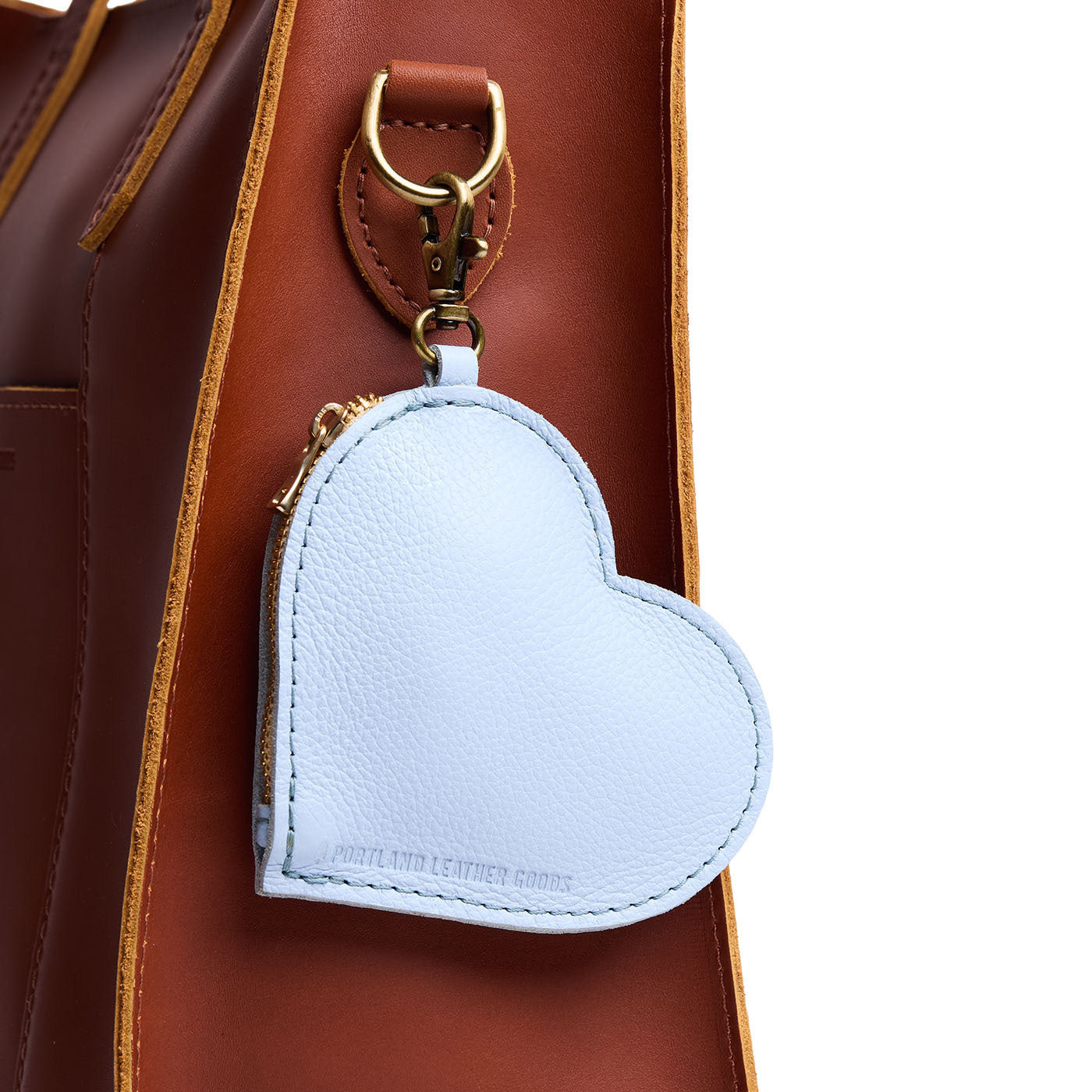 Skyway | Heart-shaped leather pouch keychain with zipper top and lobster clasp