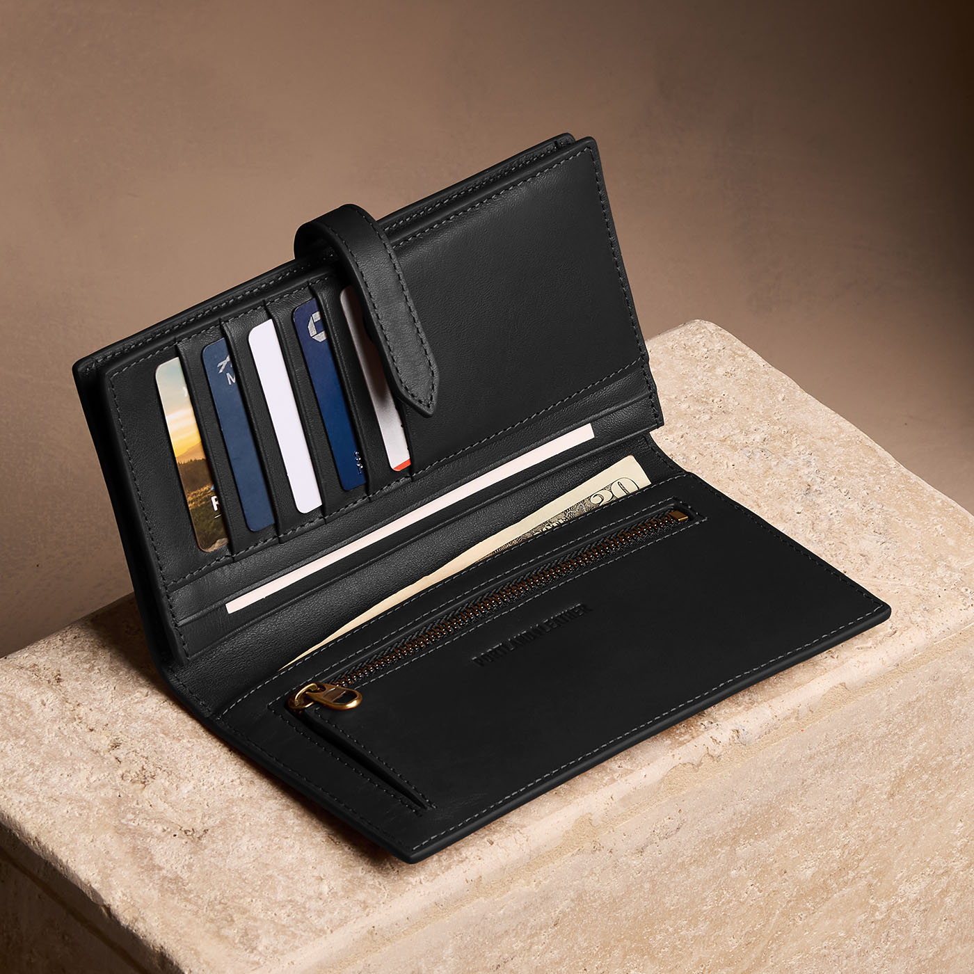 Onyx*Large | Leather bifold wallet with a strap and bar closure