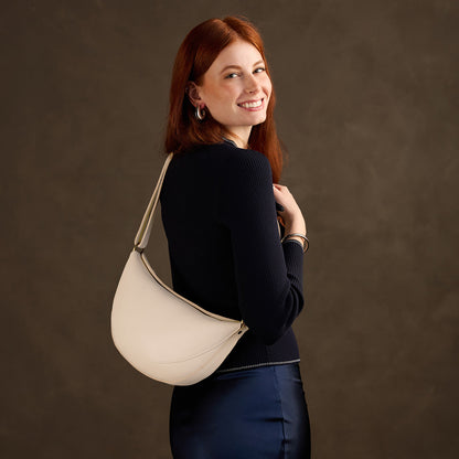 Pebbled Bone*Large | Model wearing half circle shaped sling bag