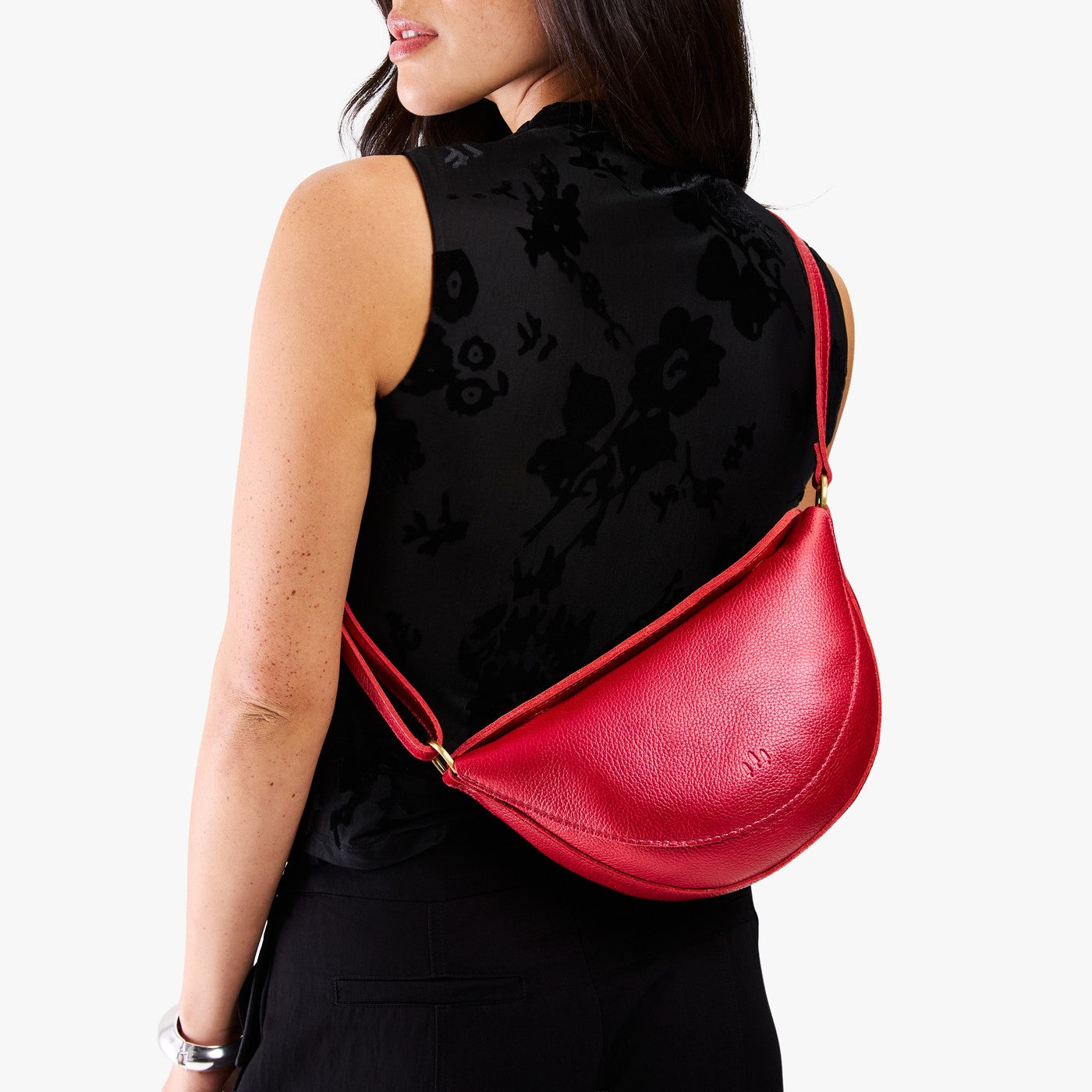 Reba Red*Medium | Model wearing half circle shaped sling bag