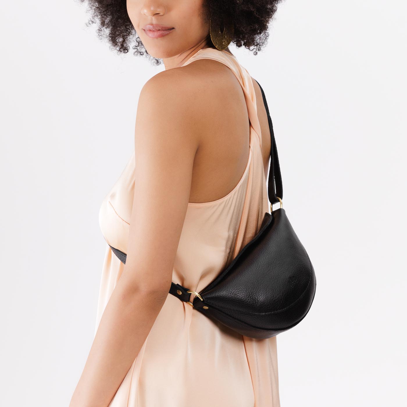 Pebbled--black*Small | Model wearing petite half circle shaped sling bag