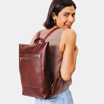 All Color: Cognac | Model wearing rectangular slim leather laptop backpack
