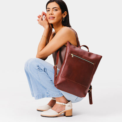 All Color: Cognac | Model wearing rectangular slim leather laptop backpack