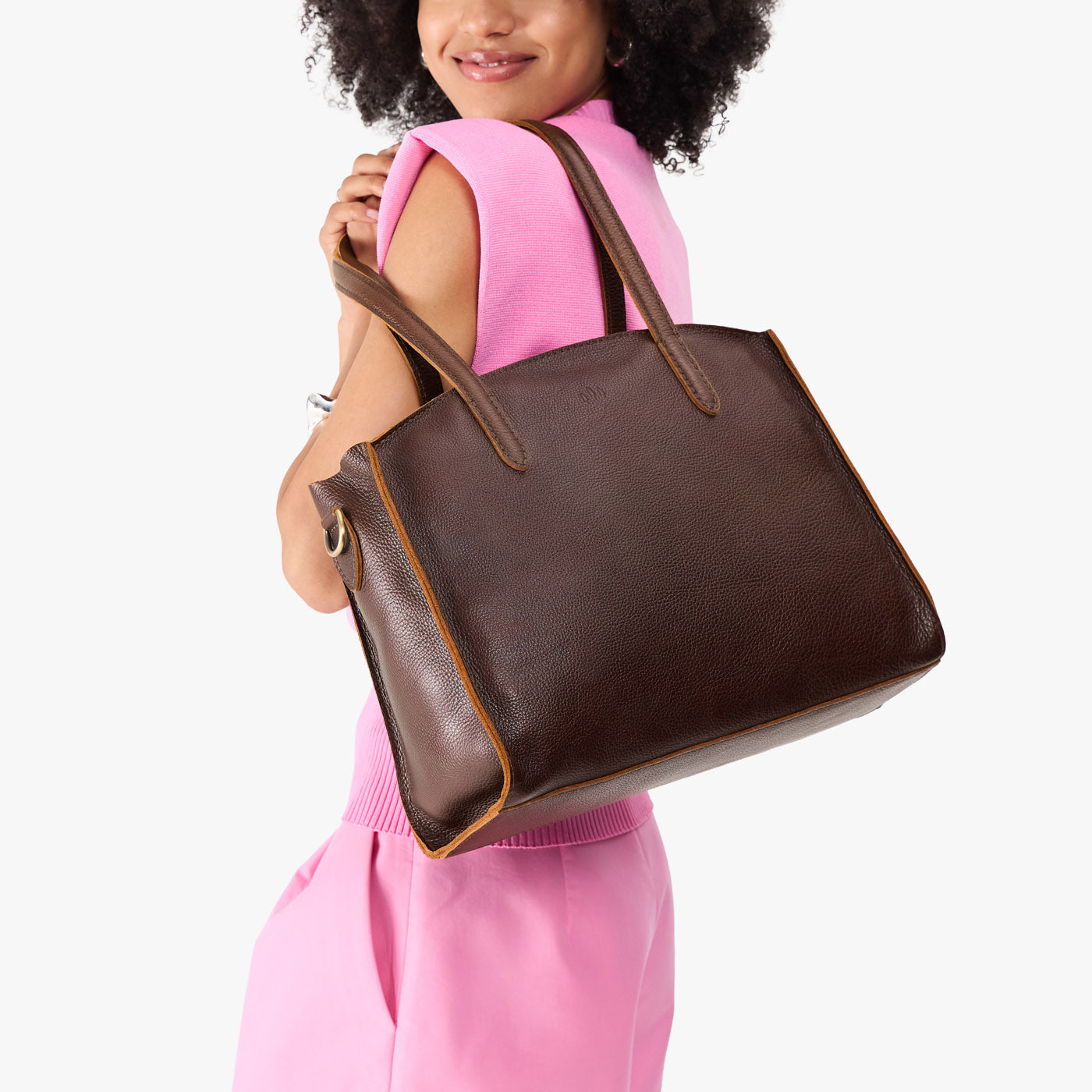 Coldbrew*Large | Model carrying leather tote bag with handles, adjustable crossbody strap, and two back pockets