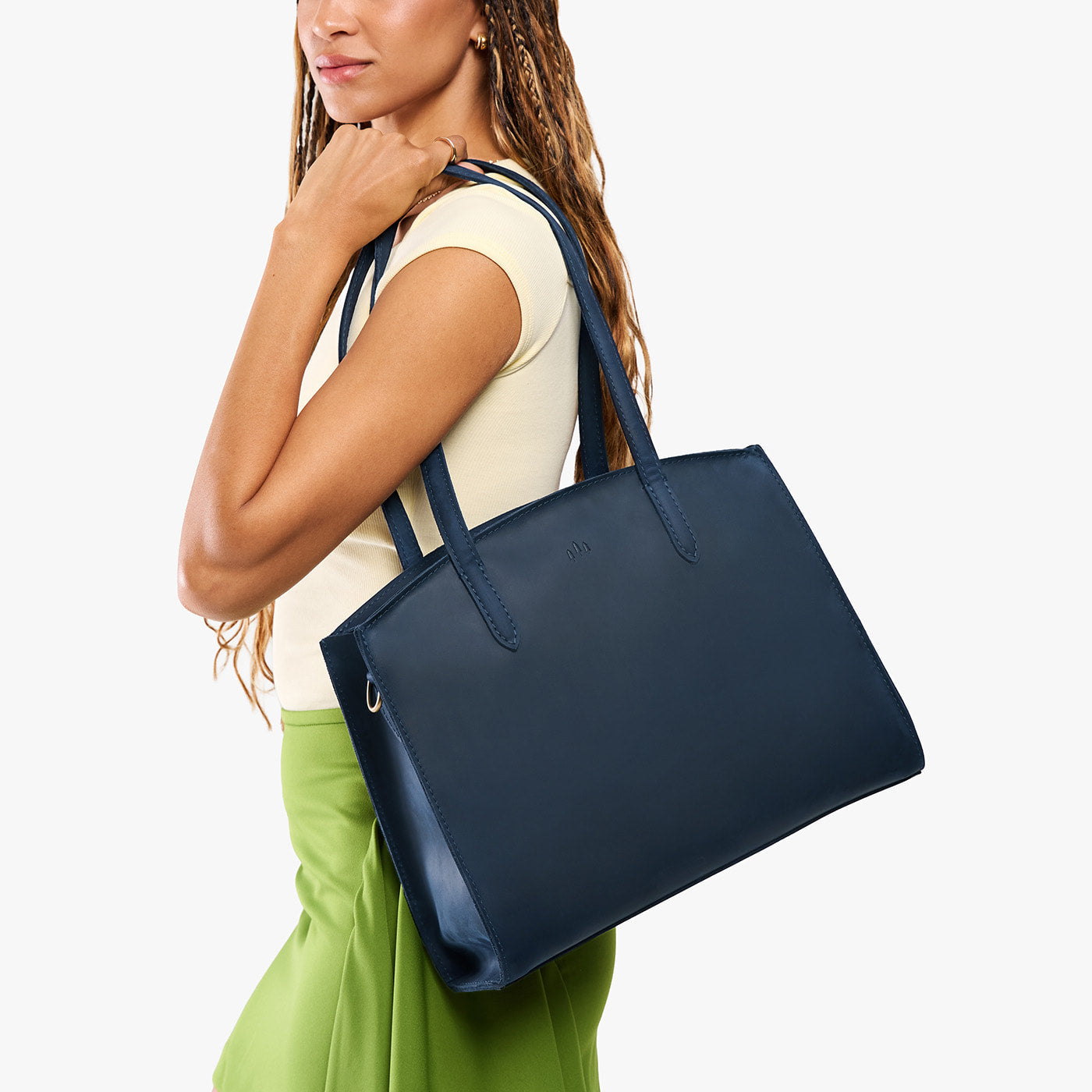 Deep Water*Large | Model carrying leather tote bag with handles, adjustable crossbody strap, and two back pockets
