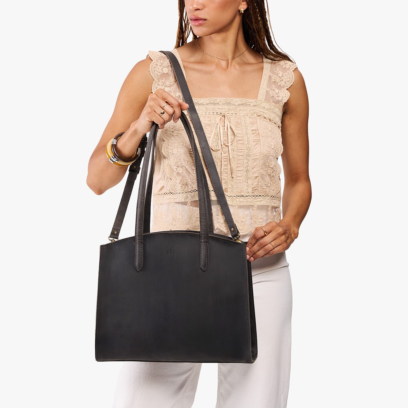 Full Moon*Large | Model carrying leather tote bag with handles, adjustable crossbody strap, and two back pockets