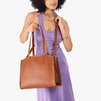 Honey*Large | Model carrying leather tote bag with handles, adjustable crossbody strap, and two back pockets