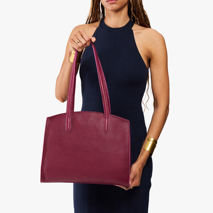 Orchid*Large | Model carrying leather tote bag with handles, adjustable crossbody strap, and two back pockets