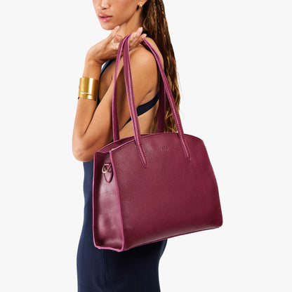 Orchid*Large | Model carrying leather tote bag with handles, adjustable crossbody strap, and two back pockets