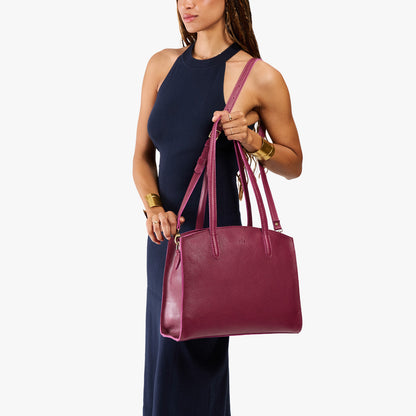 Orchid*Large | Model carrying leather tote bag with handles, adjustable crossbody strap, and two back pockets