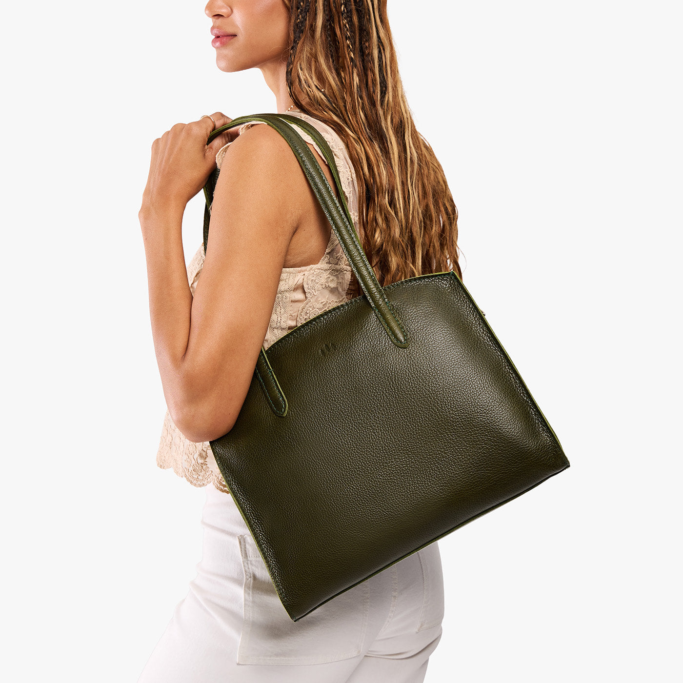Pebbled Olive*Large | Model carrying leather tote bag with handles, adjustable crossbody strap, and two back pockets