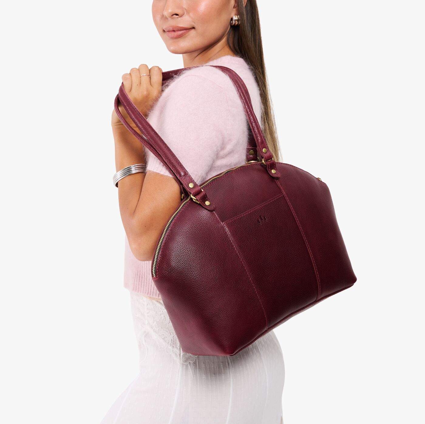 Cabernet*Large | Model holding a half circle crossbody bag with handles and removable crossbody strap