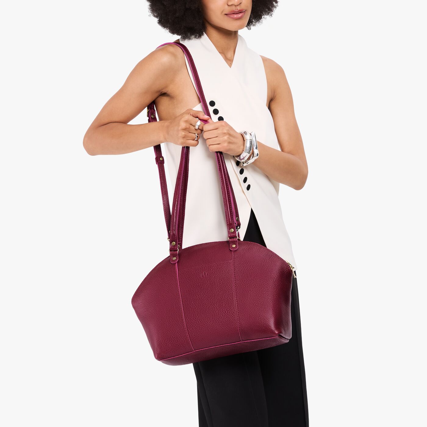 Orchid*Large | Model holding a half circle crossbody bag with handles and removable crossbody strap