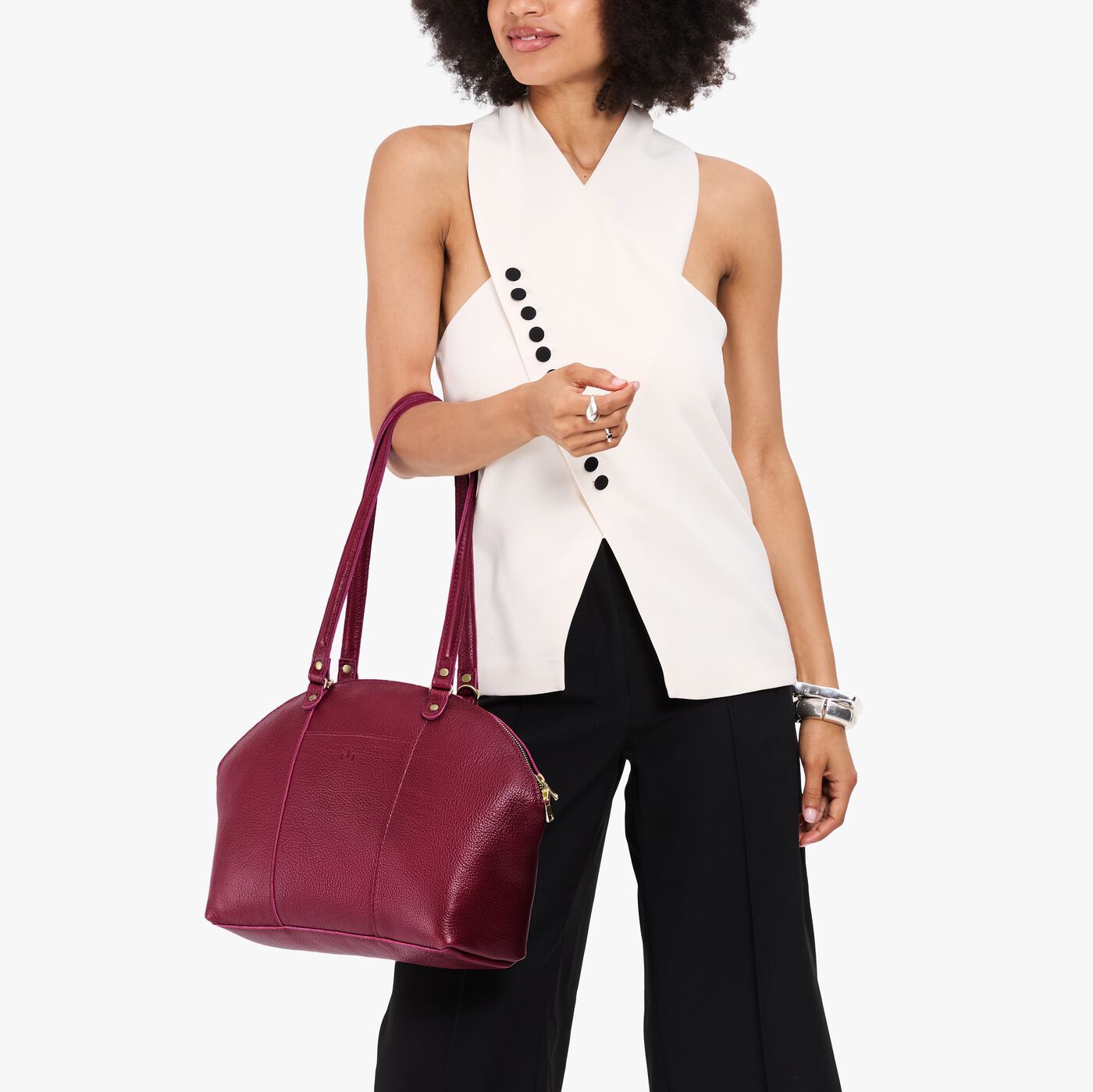 Orchid*Large | Model holding a half circle crossbody bag with handles and removable crossbody strap