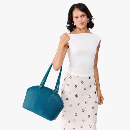 Planetary*Large | Model holding a half circle crossbody bag with handles and removable crossbody strap