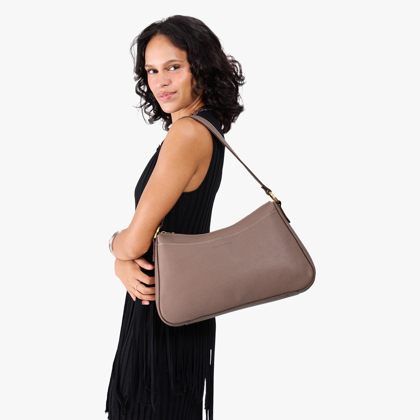 Sparrow*Large | Model holding a bean shaped shoulder bag with a zipper closure