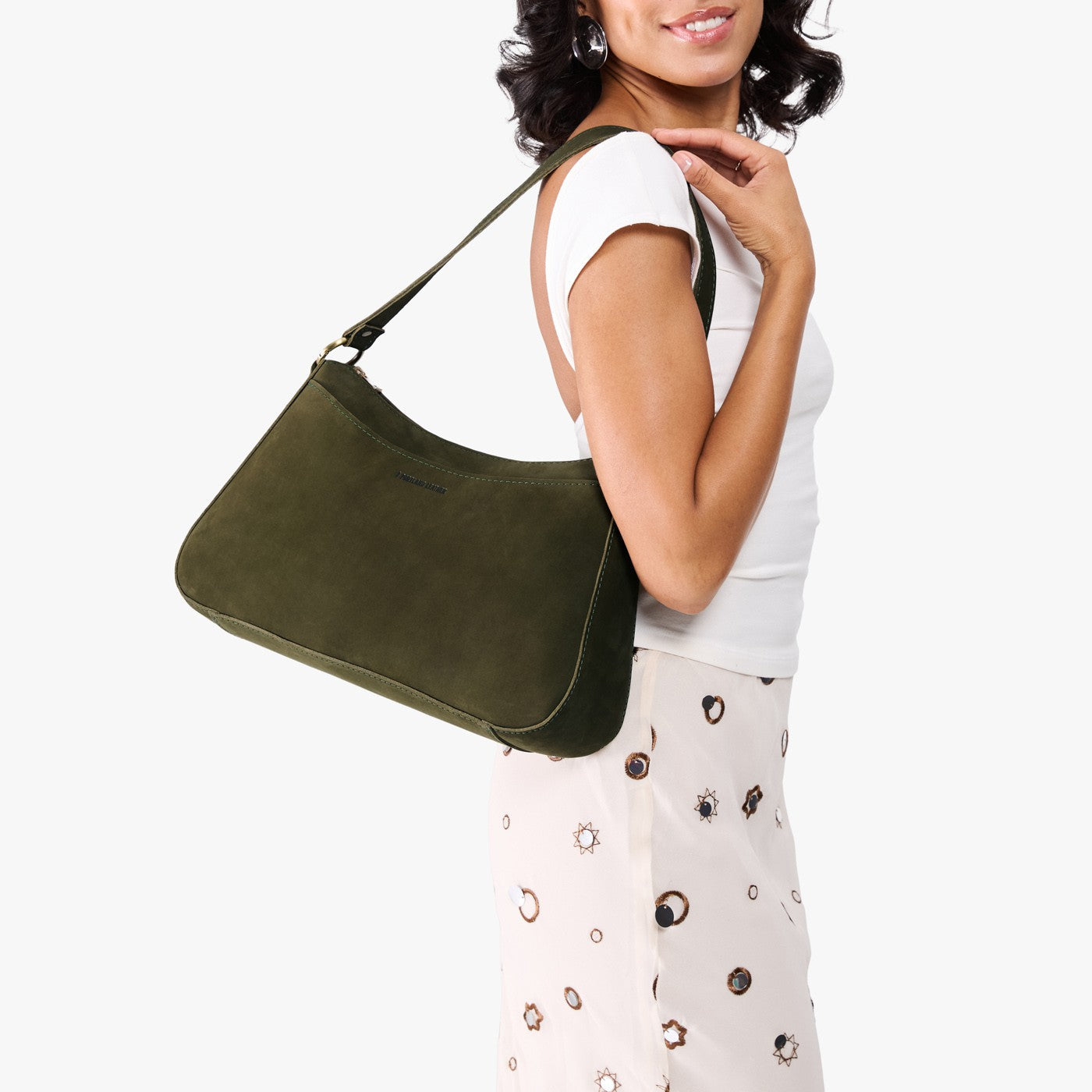 Verdant*Large | Model holding a bean shaped shoulder bag with a zipper closure