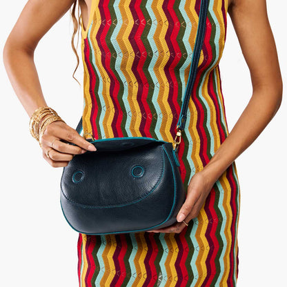 Boreal*Large | Model wearing a leather Crossbody with a flap and magnetic closure