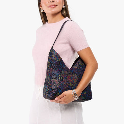 Carnival*Large | Model holding mid-size shoulder bag with magnetic snap closure
