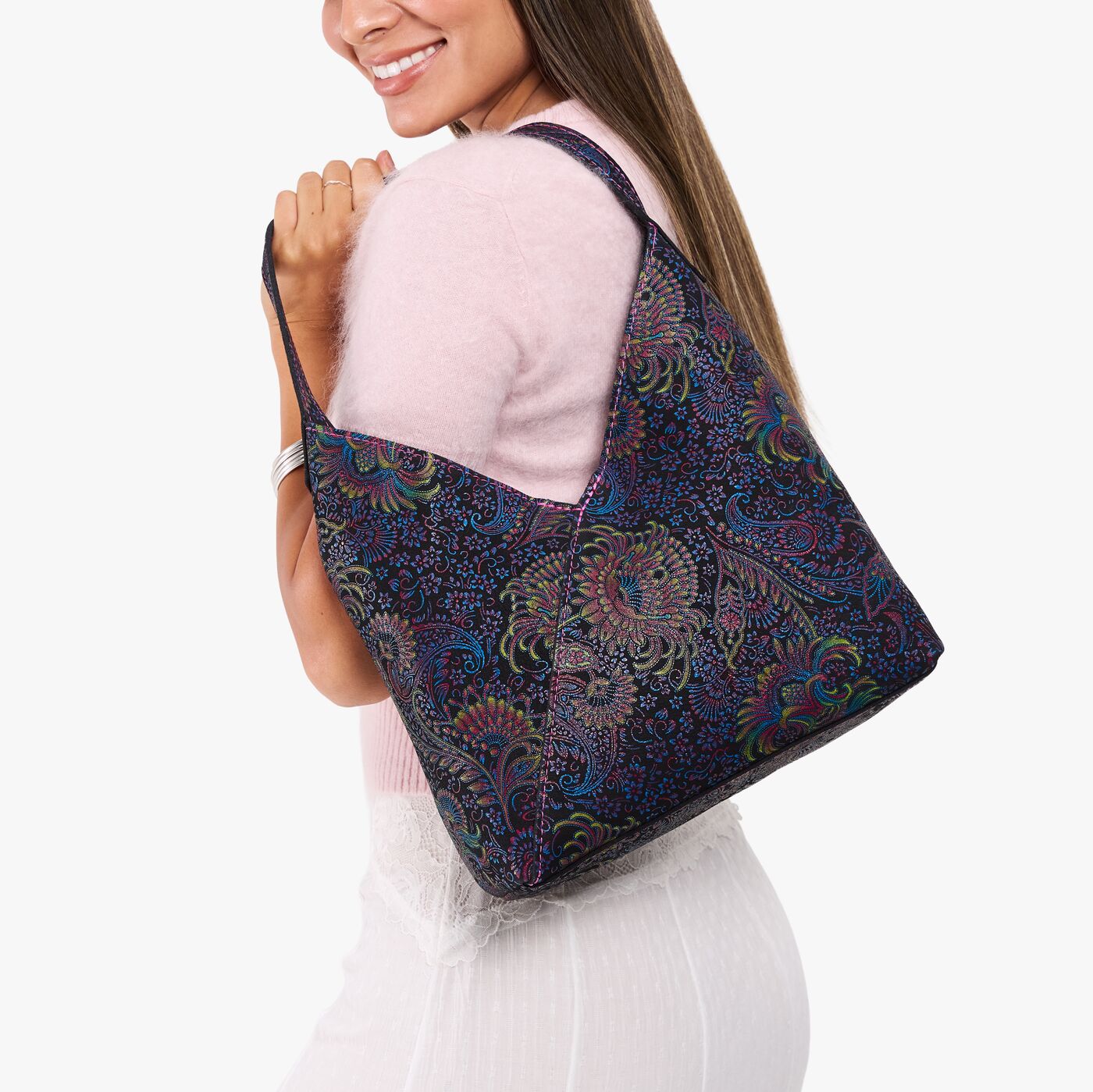 Carnival*Large | Model holding mid-size shoulder bag with magnetic snap closure