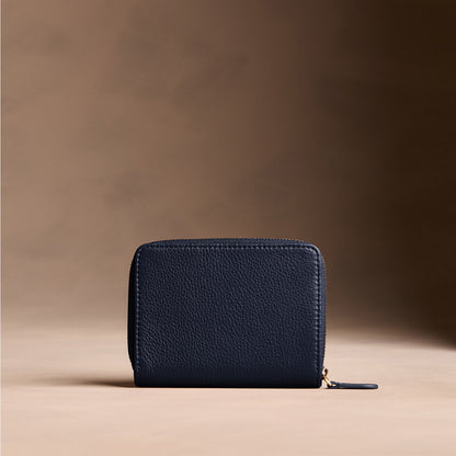 Anchor Blue | Wallet with card and storage pockets on a light brown background - back view