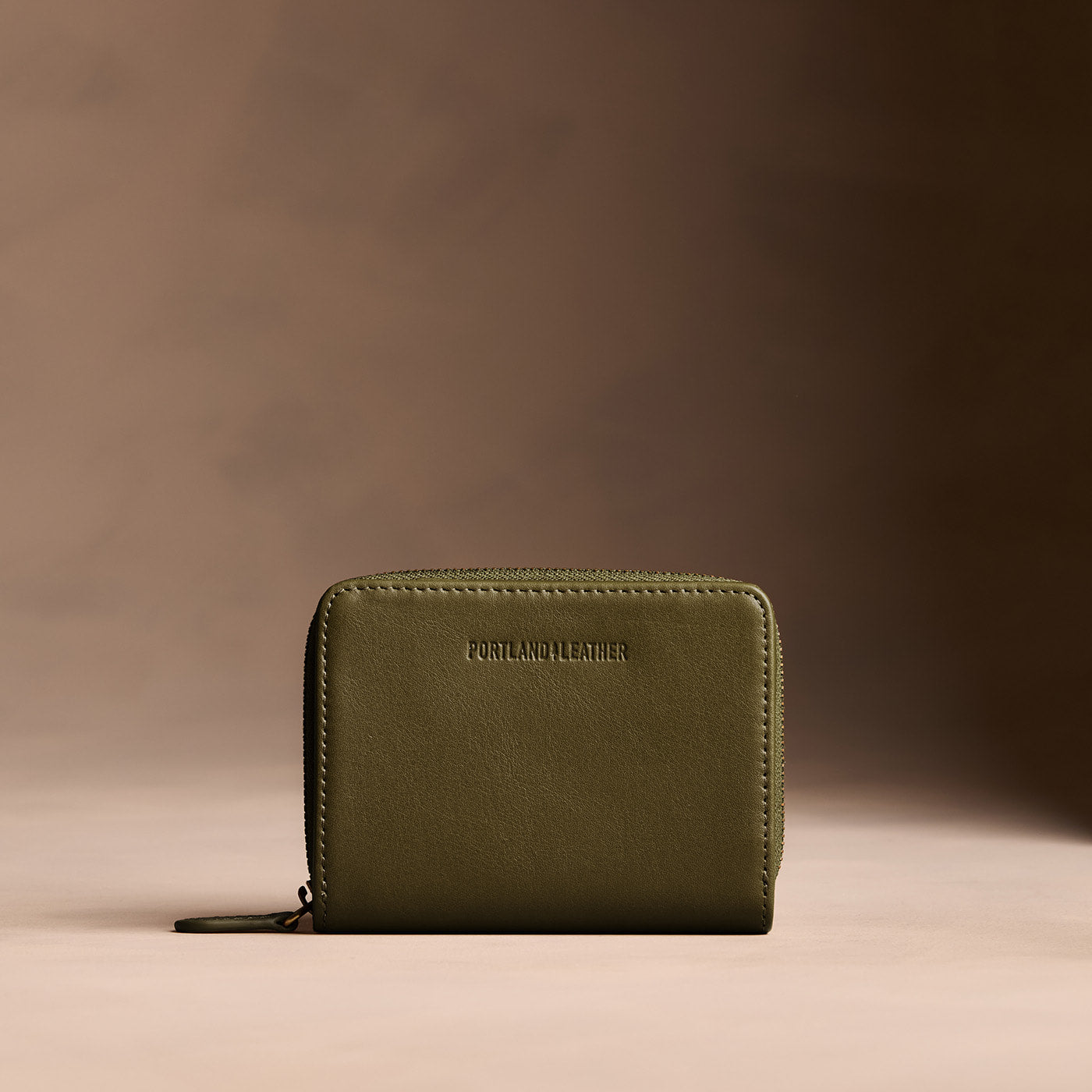 Bay Green | Wallet with card and storage pockets on a light brown background