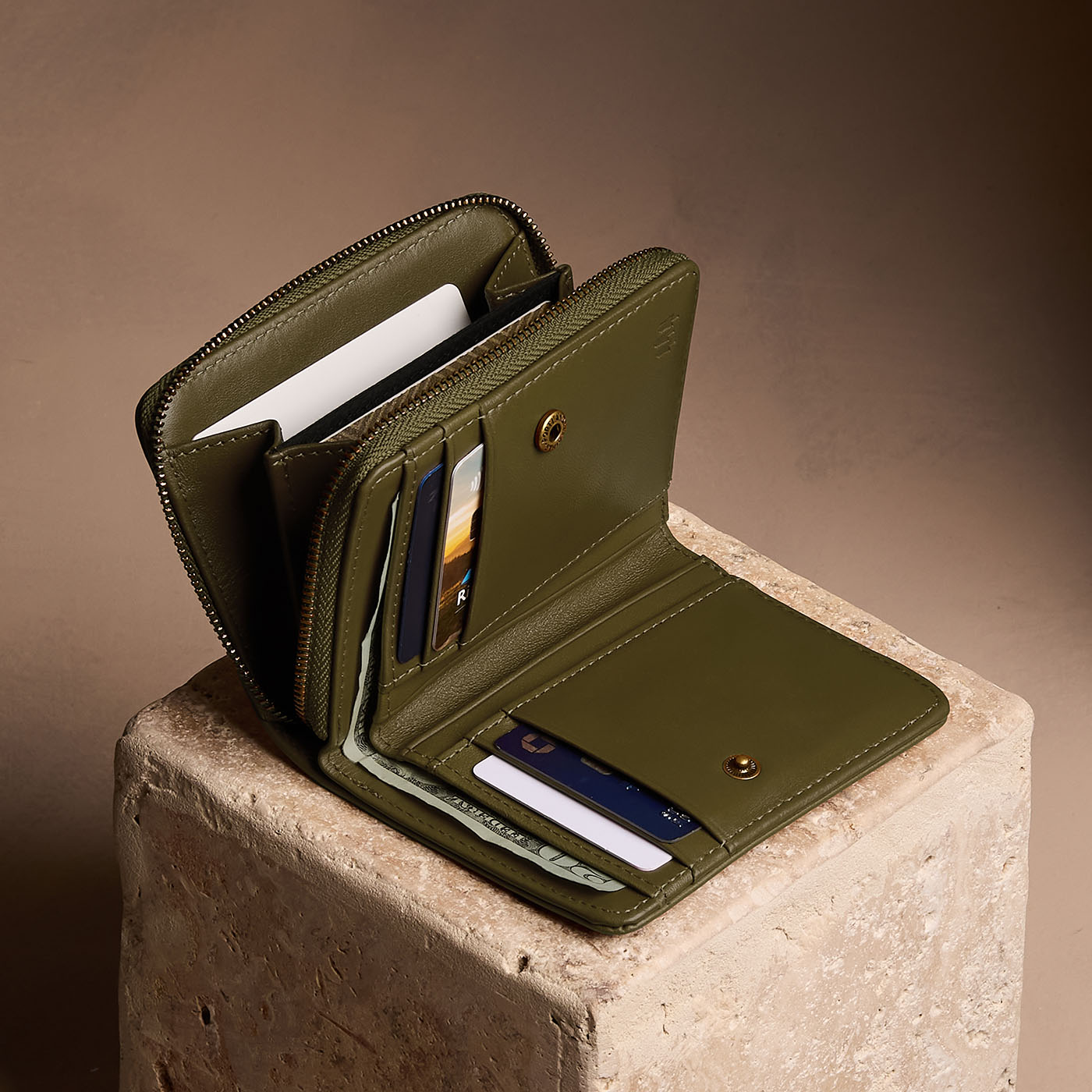 Bay Green | Open wallet with card and storage pockets on a light brown background
