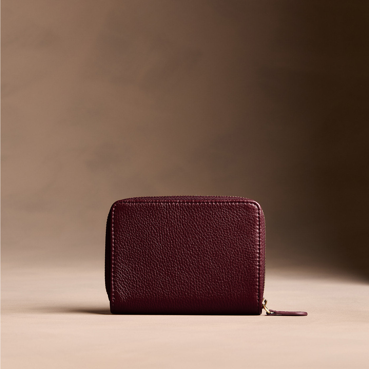 Hunter | Wallet with card and storage pockets on a light brown background - back view