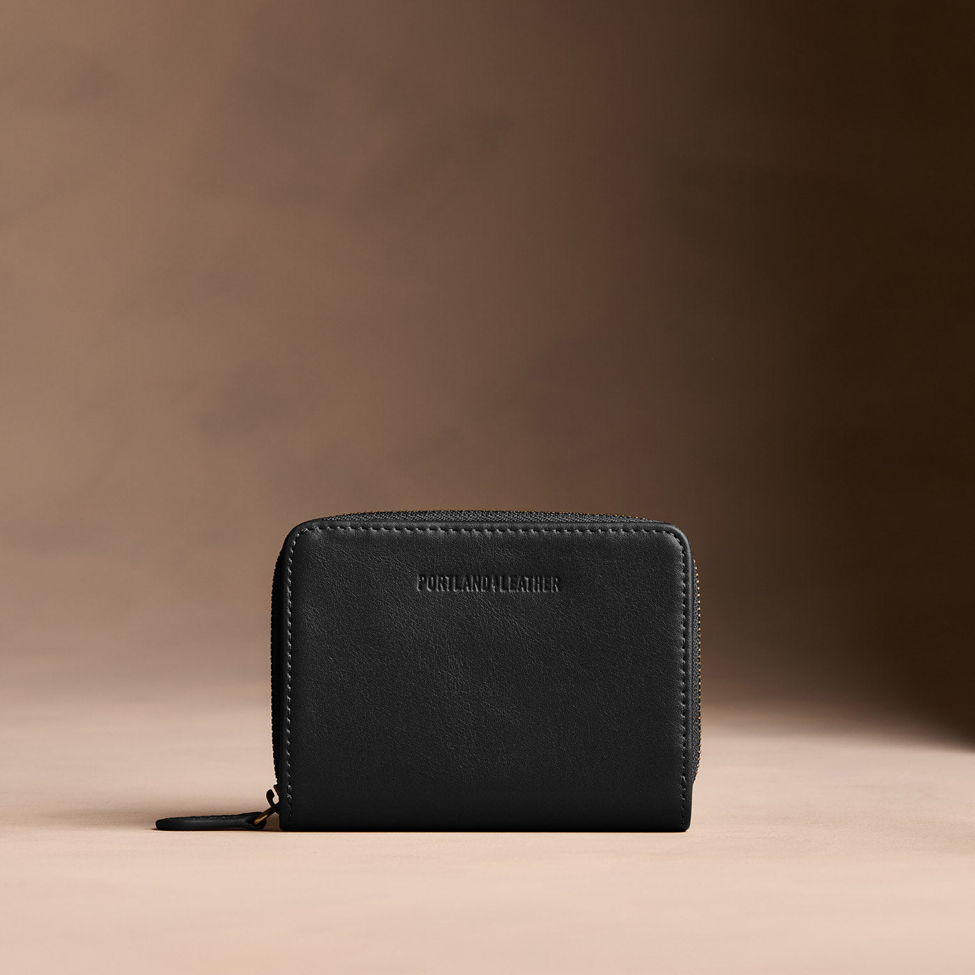 Onyx | Wallet with card and storage pockets on a light brown background