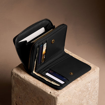 Onyx | Open wallet with card and storage pockets on a light brown background