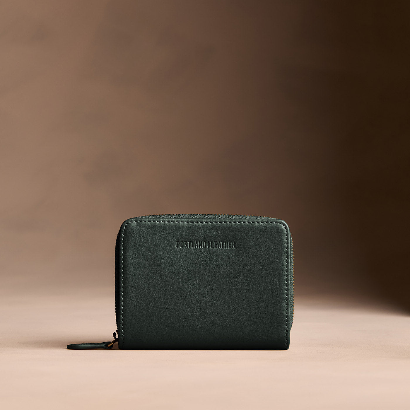 Regent Green | Wallet with card and storage pockets on a light brown background