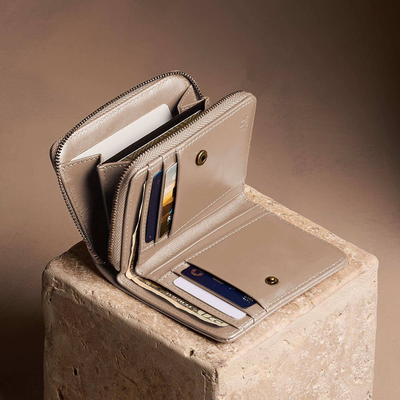 Satine | Open wallet with card and storage pockets on a light brown background