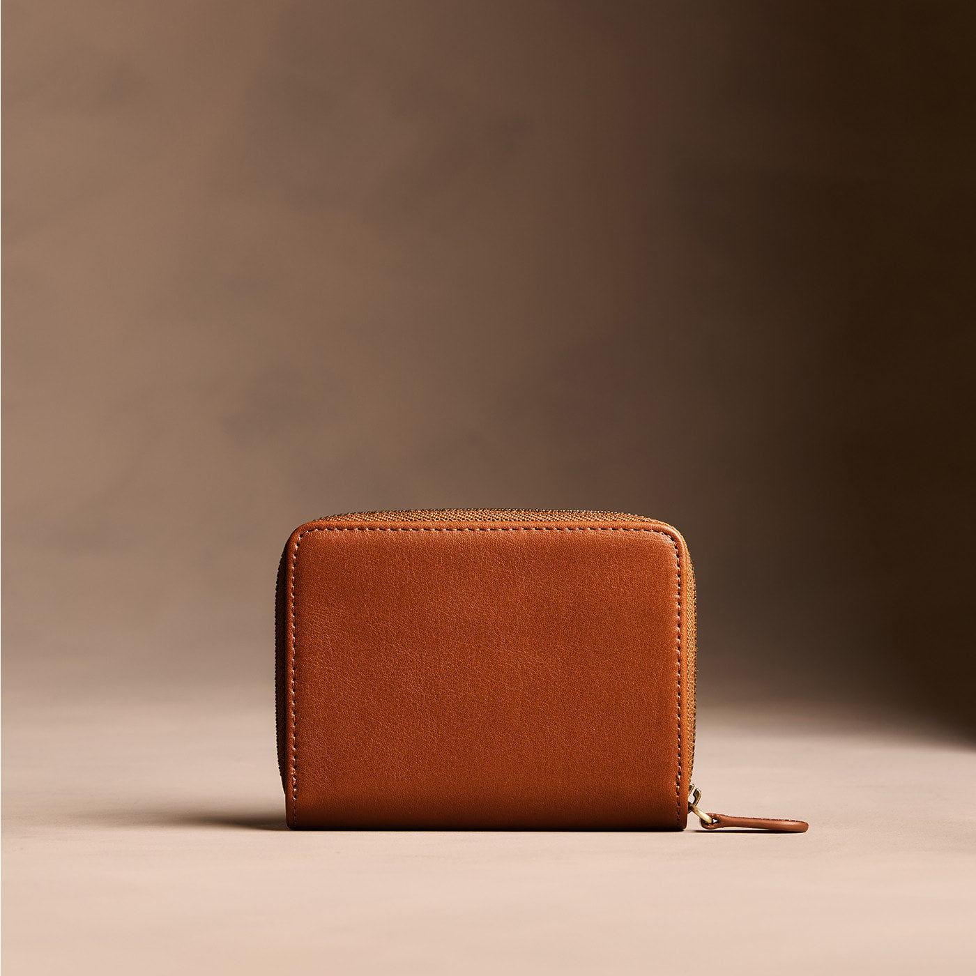 Vintage Tan | Wallet with card and storage pockets on a light brown background - back view