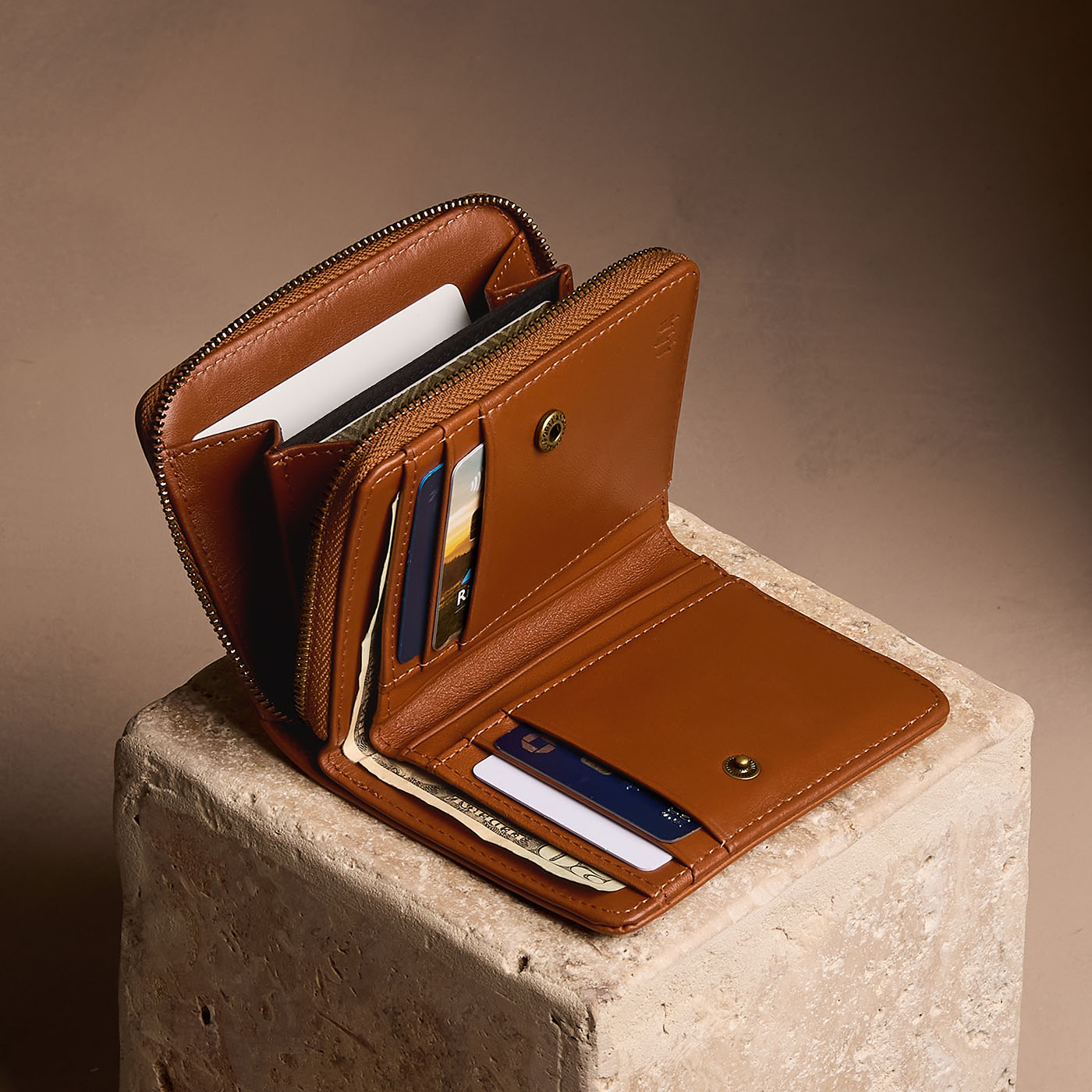 Vintage Tan | Open wallet with card and storage pockets on a light brown background