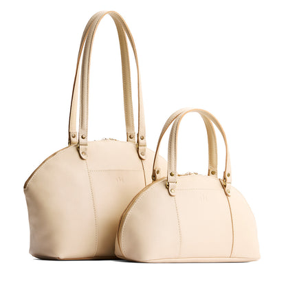 Pebbled Bone | Size comparison of the large and small half circle crossbody bag with handles and removable crossbody strap