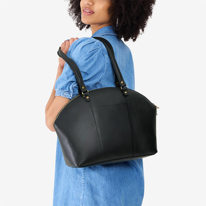 Black*Large | Model holding a half circle crossbody bag with handles and removable crossbody strap