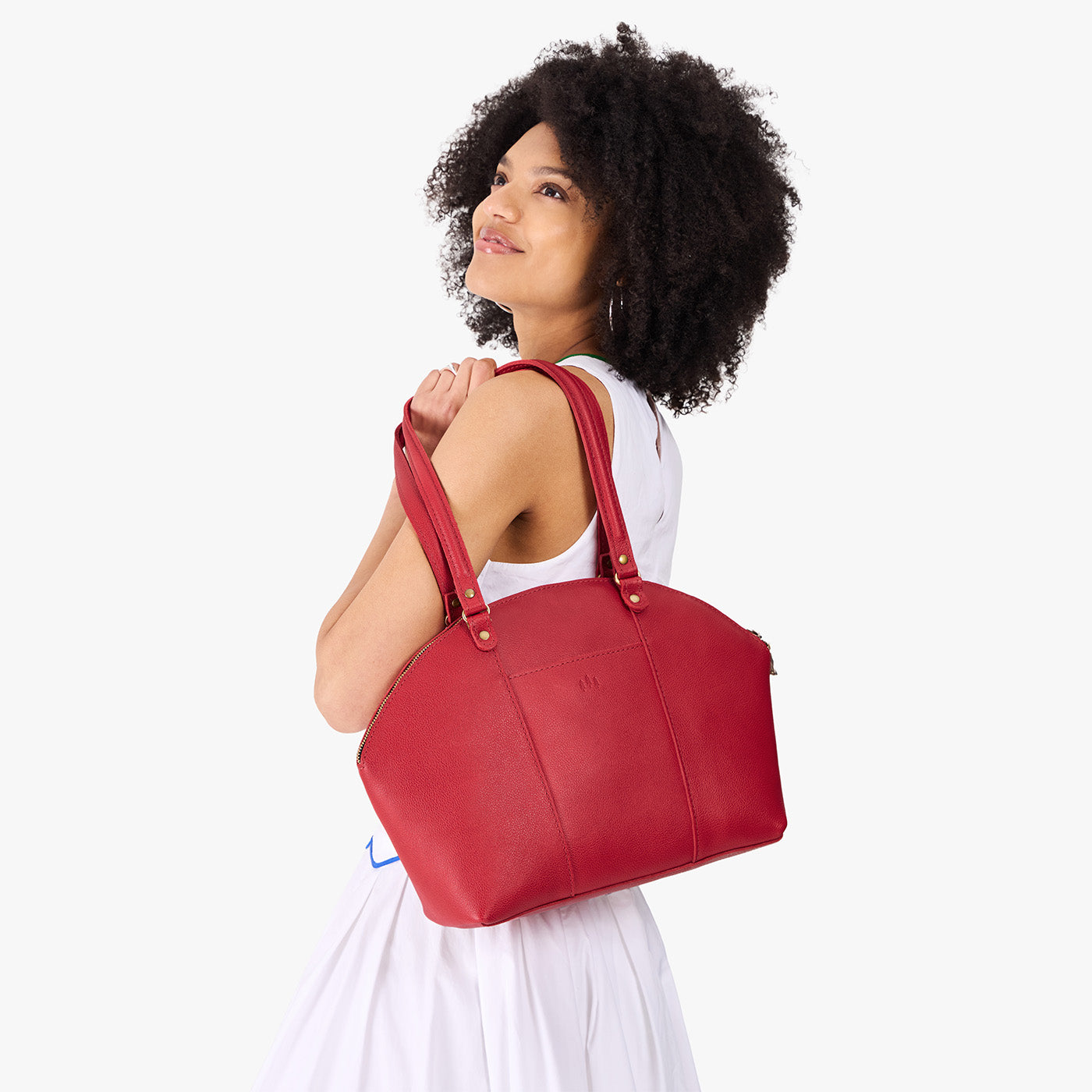 Cherry*Large | Model holding a half circle crossbody bag with handles and removable crossbody strap
