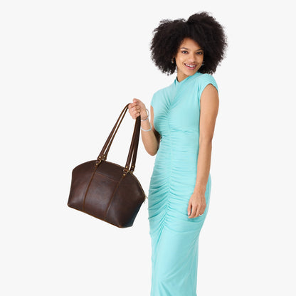 Coldbrew*Large | Model holding a half circle crossbody bag with handles and removable crossbody strap