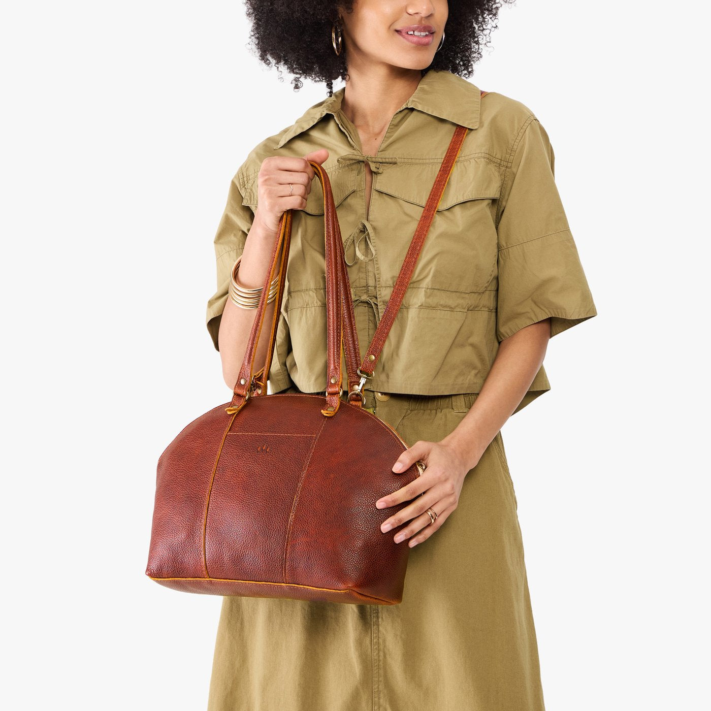 Nutmeg*Large | Model holding a half circle crossbody bag with handles and removable crossbody strap