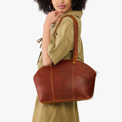Nutmeg*Large | Model holding a half circle crossbody bag with handles and removable crossbody strap