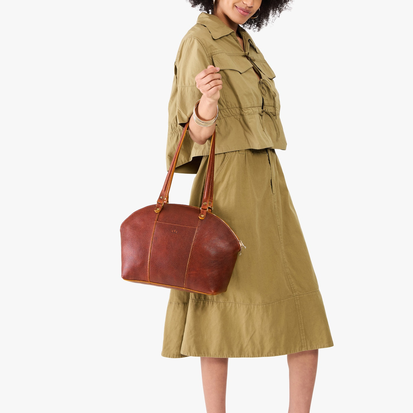 Nutmeg*Large | Model holding a half circle crossbody bag with handles and removable crossbody strap