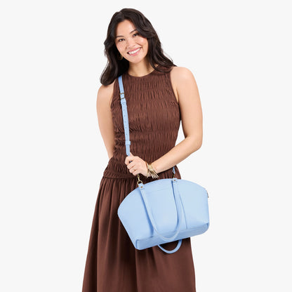 Skyway*Large | Model holding a half circle crossbody bag with handles and removable crossbody strap