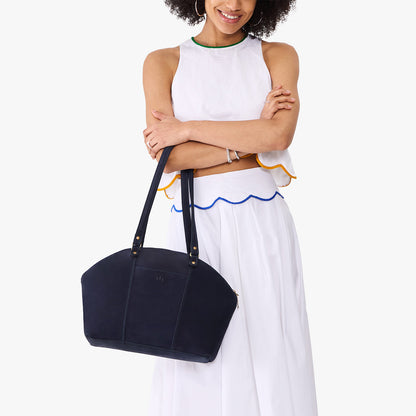 Velvet Blue*Large | Model holding a half circle crossbody bag with handles and removable crossbody strap