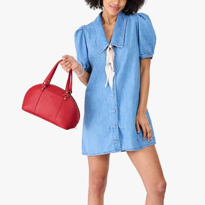 Cherry*Small | Model holding a half circle crossbody bag with handles and removable crossbody strap
