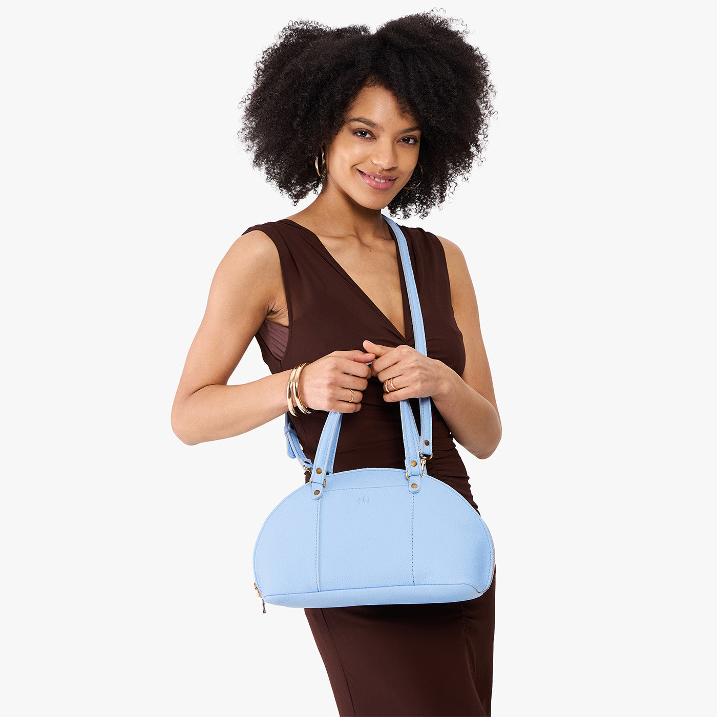 Skyway*Small | Model holding a half circle crossbody bag with handles and removable crossbody strap