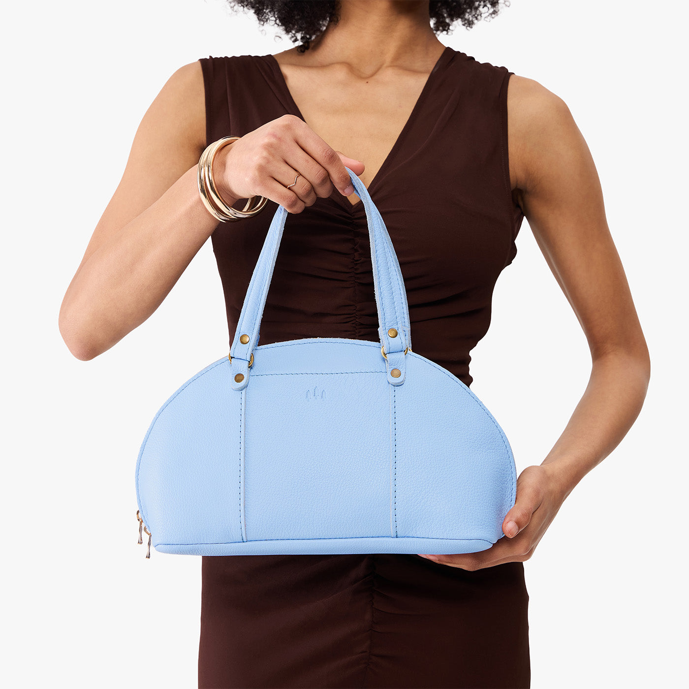 Skyway*Small | Model holding a half circle crossbody bag with handles and removable crossbody strap