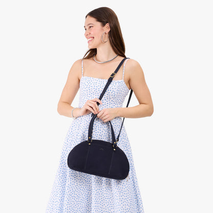 Velvet Blue*Small | Model holding a half circle crossbody bag with handles and removable crossbody strap