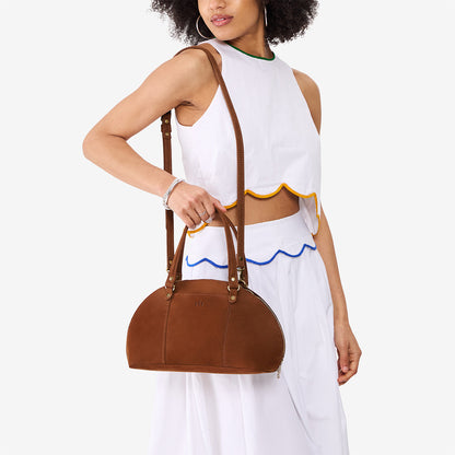 Wildwood*Small | Model holding a half circle crossbody bag with handles and removable crossbody strap
