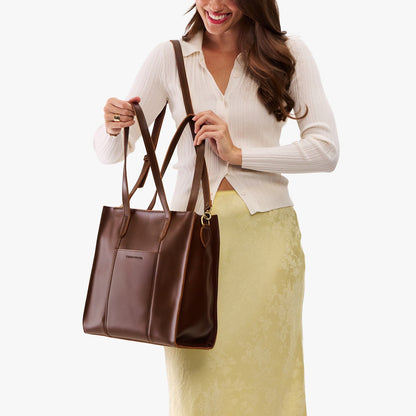 Chocolate Brown*North/South | Model wearing structured large tote bag with overlapping panels and crossbody strap